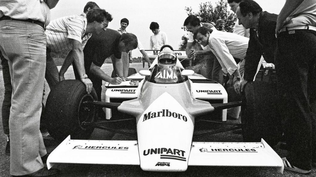 Hans Mezger (on the right by the car wearing a white shirt) when John Watson first drove the TAG Turbo in the McLaren chassis on June 29, 1982